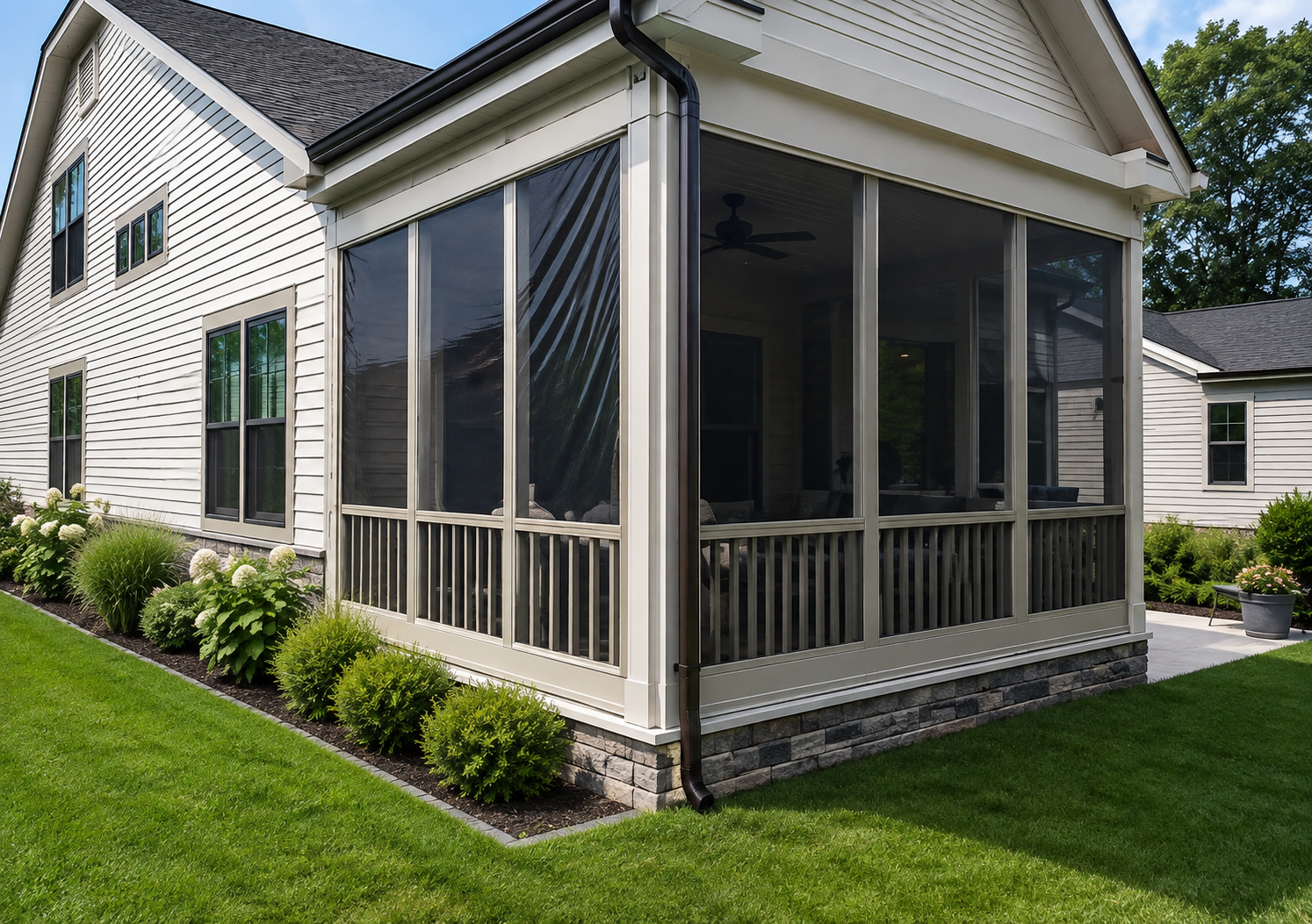 Screened-in porch with tan framing and full-height retractable screens on a white clapboard home
